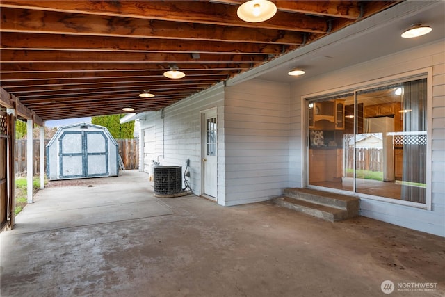 312 N Perry Ave, East Wenatchee, WA 98802 - view of patio featuring fence, entry steps, an outbuilding, cooling unit, and a shed