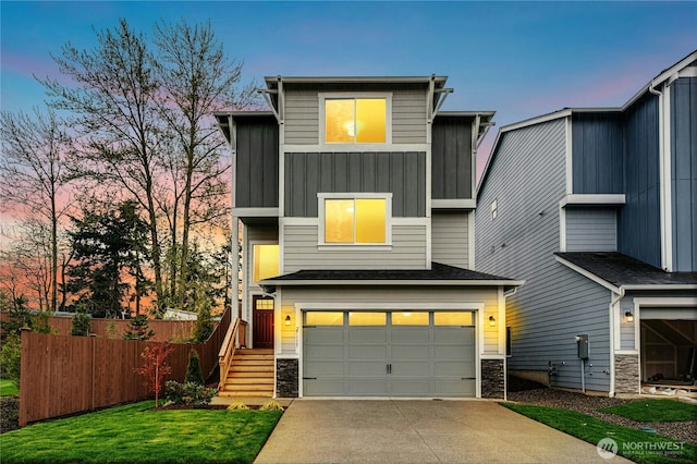 27113 30th Pl S Unit 23, Kent, WA 98032 - view of front of house with board and batten siding, stone siding, a garage, driveway, and fence