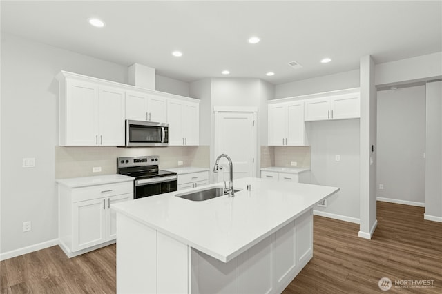 27113 30th Pl S Unit 23, Kent, WA 98032 - kitchen with appliances with stainless steel finishes, a sink, a center island with sink, white cabinets, and recessed lighting