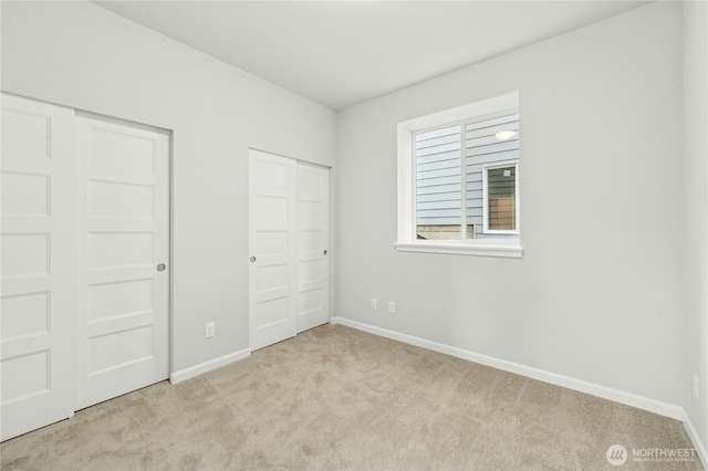 27113 30th Pl S Unit 23, Kent, WA 98032 - unfurnished bedroom with light colored carpet, baseboards, and multiple closets