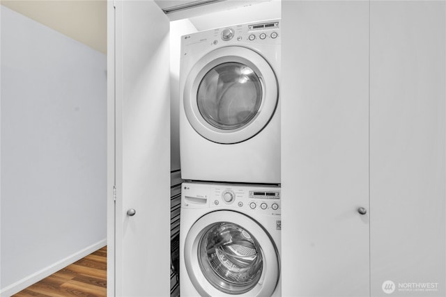 500 Elliott Ave W Unit 309, Seattle, WA 98119 - laundry room featuring stacked washing machine and dryer and wood finished floors