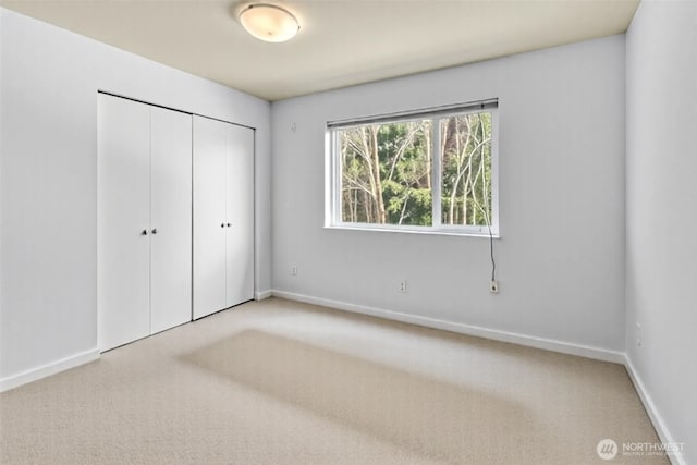 500 Elliott Ave W Unit 309, Seattle, WA 98119 - unfurnished bedroom with carpet floors, a closet, and baseboards