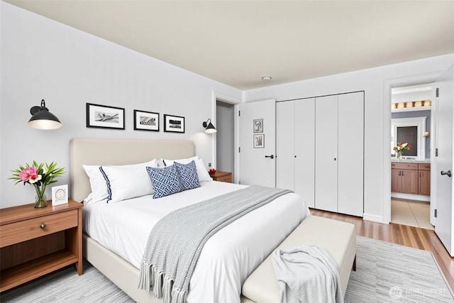 500 Elliott Ave W Unit 309, Seattle, WA 98119 - bedroom with light wood-style flooring, a closet, and ensuite bathroom