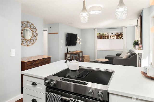 756 N 72nd St Unit 101, Seattle, WA 98103 - kitchen featuring white cabinets, light countertops, decorative light fixtures, and electric stove