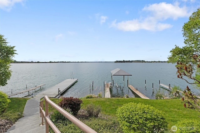 dock area featuring boat lift and a water view