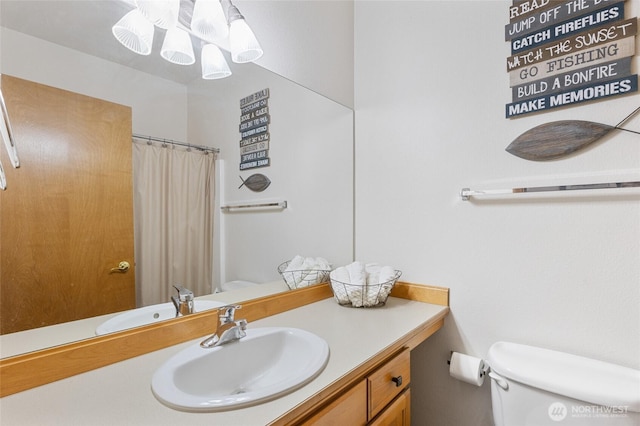 full bathroom with vanity, a shower with curtain, and toilet