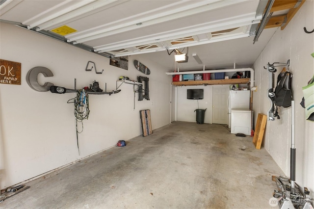 garage with freestanding refrigerator and a garage door opener