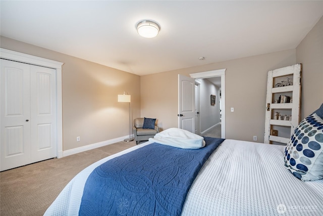 carpeted bedroom featuring a closet and baseboards