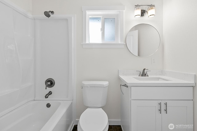 full bathroom featuring baseboards, toilet, vanity, and washtub / shower combination