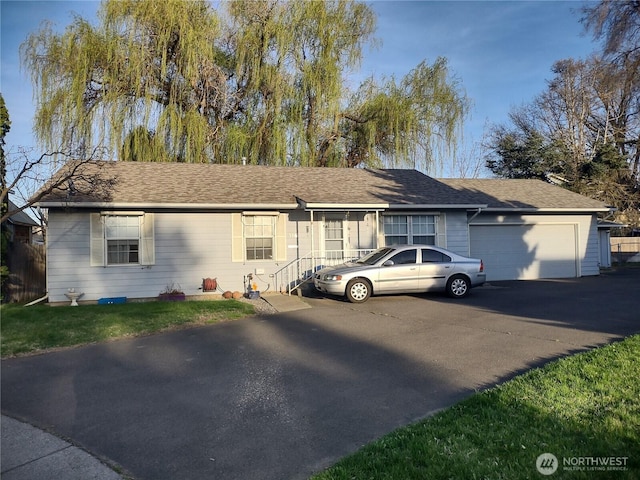 312 SE 9th St, College Place, WA 99324 - ranch-style house featuring roof with shingles, a front yard, a garage, and aphalt driveway
