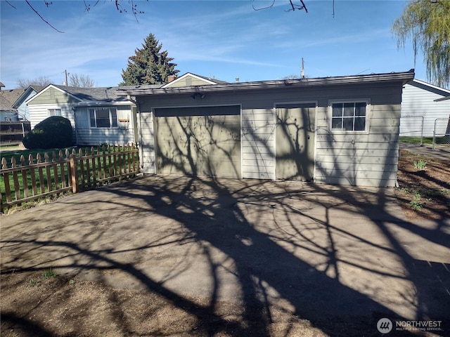 312 SE 9th St, College Place, WA 99324 - rear view of property with driveway, fence, and an attached garage