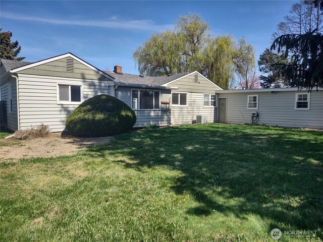 312 SE 9th St, College Place, WA 99324 - back of house featuring a chimney, cooling unit, and a yard