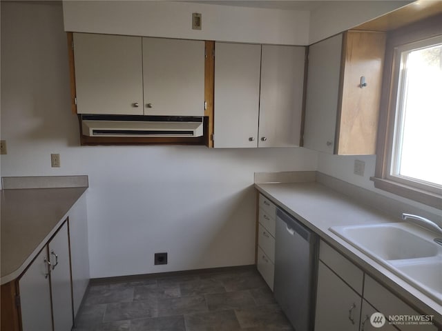 312 SE 9th St, College Place, WA 99324 - kitchen with light countertops, stone finish floor, dishwasher, baseboards, and a sink