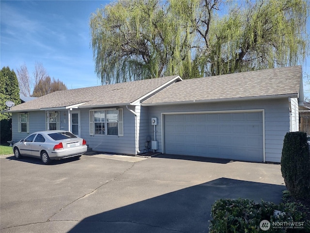 312 SE 9th St, College Place, WA 99324 - ranch-style house with a garage, concrete driveway, and roof with shingles