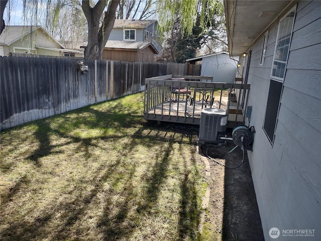 312 SE 9th St, College Place, WA 99324 - view of yard featuring a fenced backyard, a wooden deck, and central AC