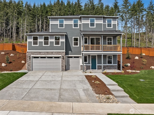 15710 210th Ave E Unit 311, Bonney Lake, WA 98391 - view of front of home featuring stone siding, a garage, covered porch, and concrete driveway