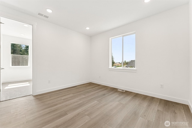 15710 210th Ave E Unit 311, Bonney Lake, WA 98391 - unfurnished room featuring light wood finished floors, baseboards, and recessed lighting