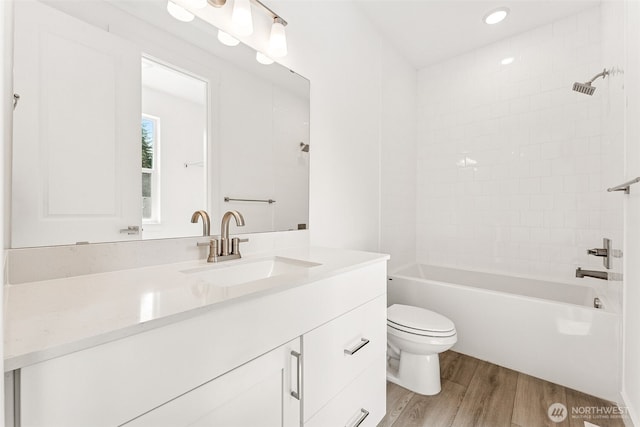 15710 210th Ave E Unit 311, Bonney Lake, WA 98391 - bathroom with wood finished floors, toilet, vanity, shower / bath combination, and recessed lighting