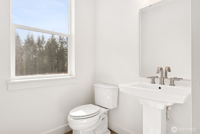 15710 210th Ave E Unit 311, Bonney Lake, WA 98391 - half bathroom featuring toilet and baseboards