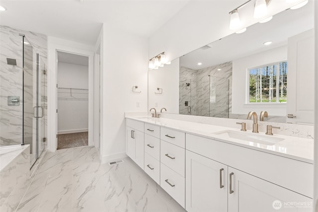 15710 210th Ave E Unit 311, Bonney Lake, WA 98391 - full bath with a marble finish shower, marble finish floors, a spacious closet, double vanity, and recessed lighting