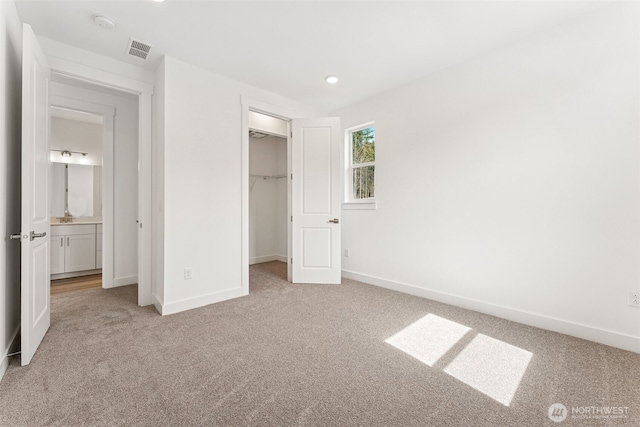 15710 210th Ave E Unit 311, Bonney Lake, WA 98391 - unfurnished bedroom featuring carpet flooring, baseboards, a spacious closet, a closet, and recessed lighting