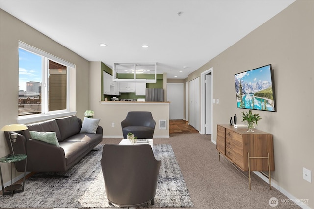 carpeted living room with baseboards, recessed lighting, and visible vents