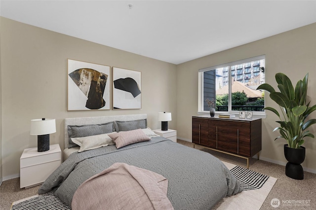 carpeted bedroom featuring baseboards