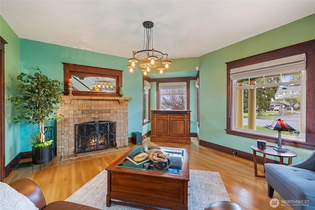 814 E Wright Ave, Tacoma, WA 98404 - living room with a tile fireplace, healthy amount of natural light, wood finished floors, and a chandelier