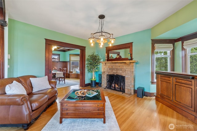 814 E Wright Ave, Tacoma, WA 98404 - living area featuring light wood finished floors, a chandelier, and a fireplace