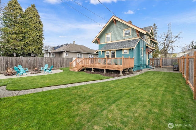 814 E Wright Ave, Tacoma, WA 98404 - rear view of property featuring an outdoor fire pit, a wooden deck, a fenced backyard, and a chimney