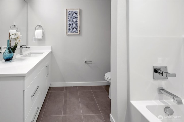 8818 NE 173rd Pl Unit B, Bothell, WA 98011 - bathroom with tile patterned floors, vanity, toilet, baseboards, and a bath