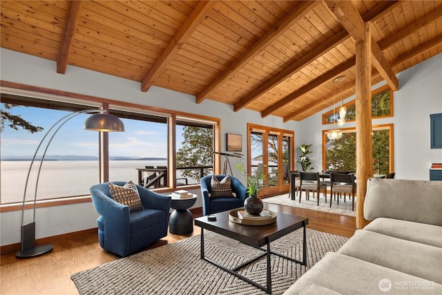 449 Madrona Dr, Friday Harbor, WA 98250 - living area featuring baseboards, high vaulted ceiling, wood finished floors, and a water view