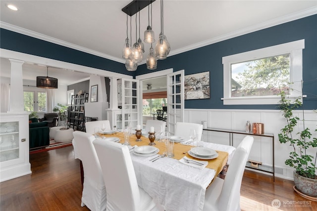 dining space featuring french doors, ornamental molding, and ornate columns