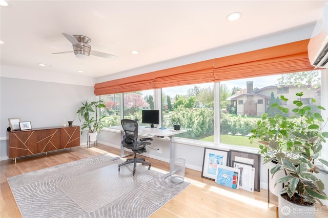 office with baseboards, a wall unit AC, recessed lighting, and wood finished floors