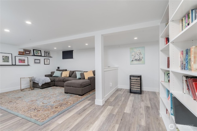 living room featuring wine cooler, recessed lighting, and light wood-style flooring