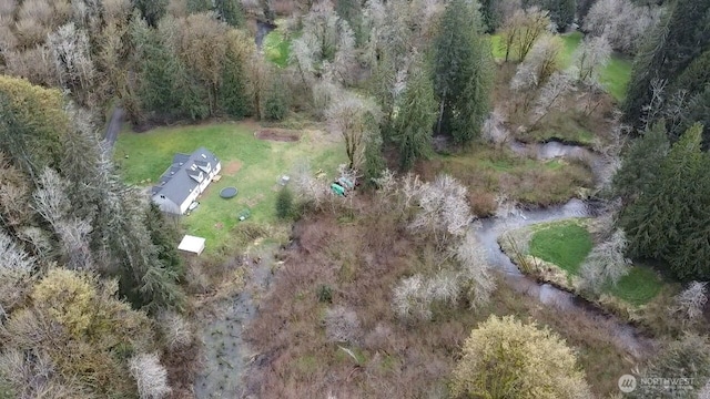 birds eye view of property featuring a wooded view