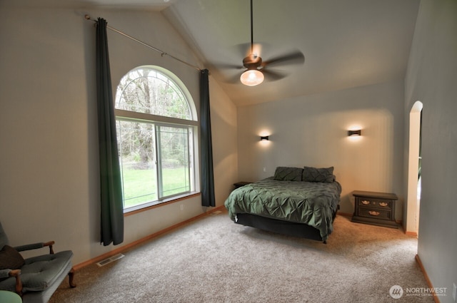 bedroom with vaulted ceiling, multiple windows, and visible vents