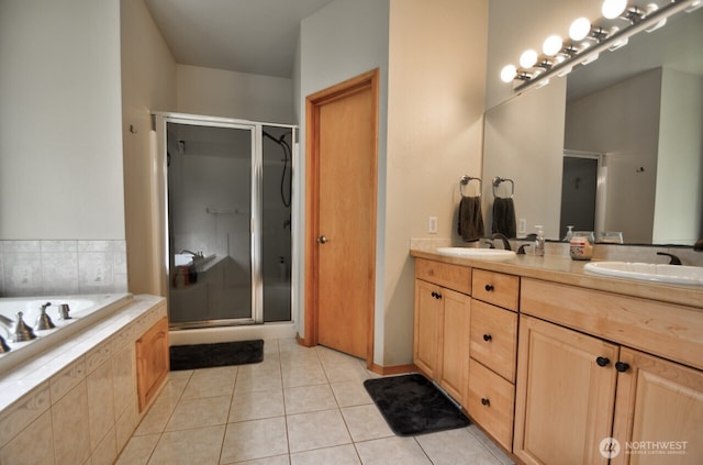 bathroom with a sink, double vanity, tile patterned flooring, a shower stall, and a garden tub