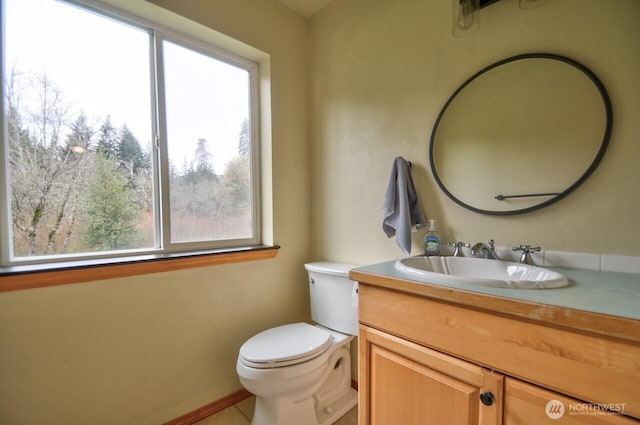 bathroom featuring tile patterned floors, vanity, and toilet