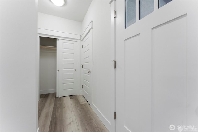 corridor featuring wood finished floors
