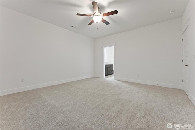 spare room featuring visible vents, light carpet, baseboards, and ceiling fan