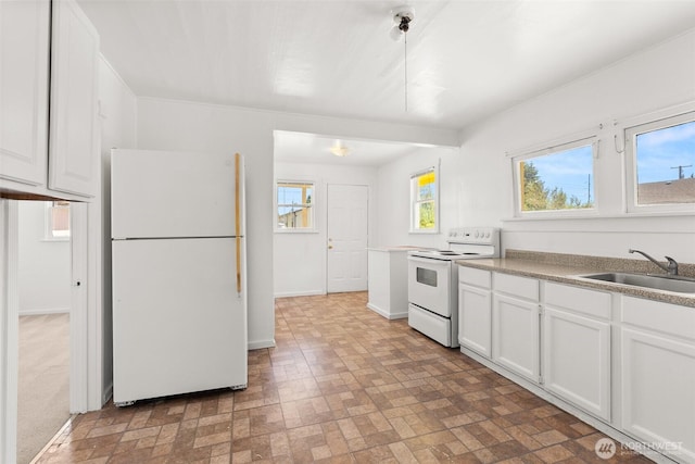 1330 Central Blvd, Centralia, WA 98531 - kitchen featuring white appliances, brick patterned flooring, white cabinets, and light countertops