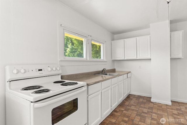 1330 Central Blvd, Centralia, WA 98531 - kitchen featuring electric range, white cabinets, and brick patterned floors