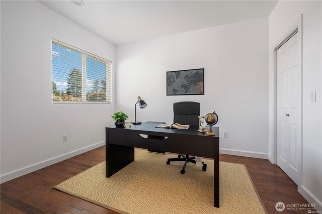 office space with baseboards and wood finished floors
