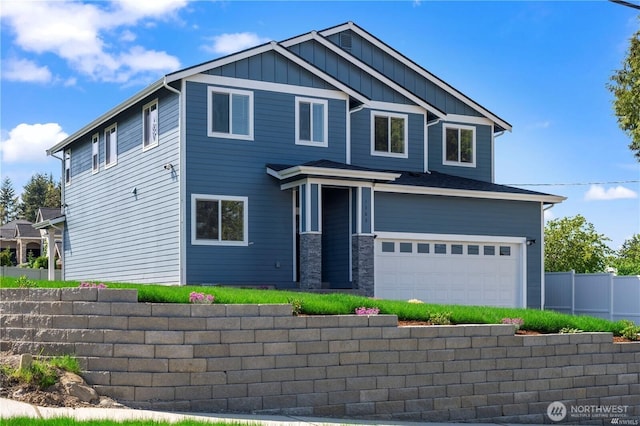 craftsman inspired home featuring an attached garage, board and batten siding, stone siding, and fence