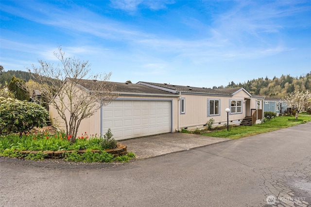 view of front of house with driveway, a shingled roof, a garage, and crawl space