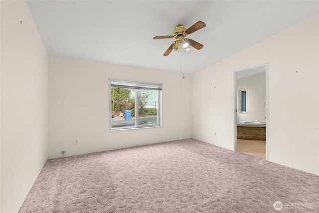 spare room with carpet, lofted ceiling, and ceiling fan