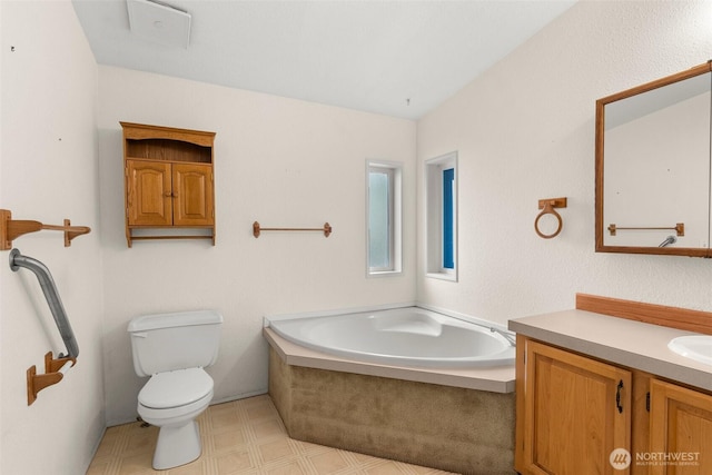 bathroom featuring a bath, tile patterned floors, toilet, and vanity