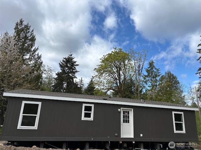 exterior space featuring a shingled roof