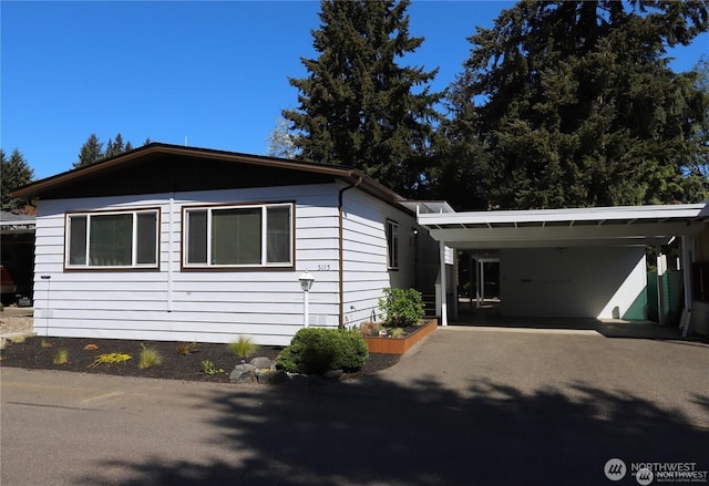 5115 88th Street Ct E Unit 29, Tacoma, WA 98446 - view of front facade featuring a carport and aphalt driveway